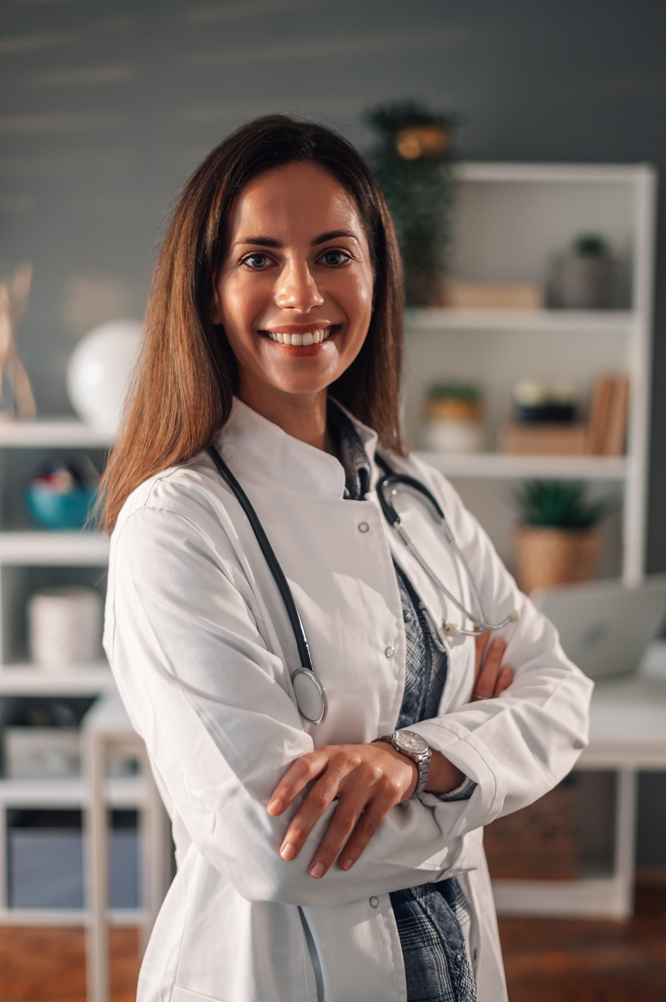 Portrait of a confident doctor standing at home and smiling at the camera.