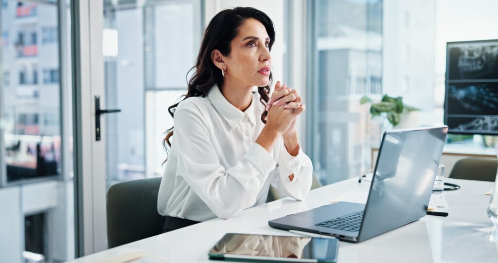 Doctor, laptop and thinking with woman in hospital for cardiology, medical or telehealth. Healthcar